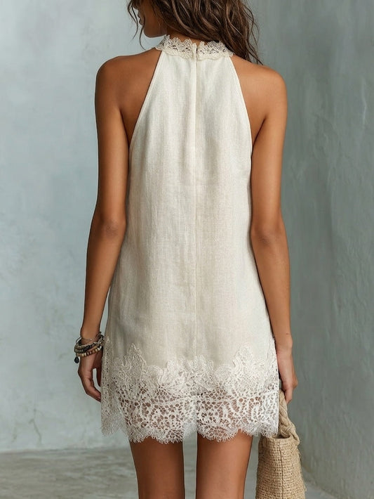 Minidress avorio svasato con scollo a halter e bordo romantico