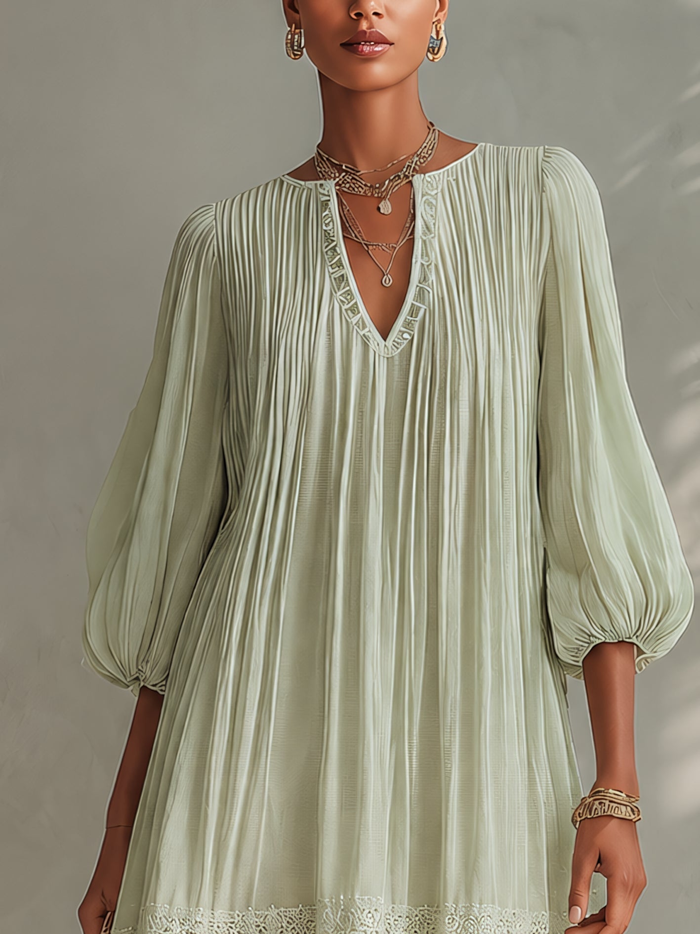 Vestito mini verde chiaro in chiffon plissettato con maniche a lanterna e pizzo
